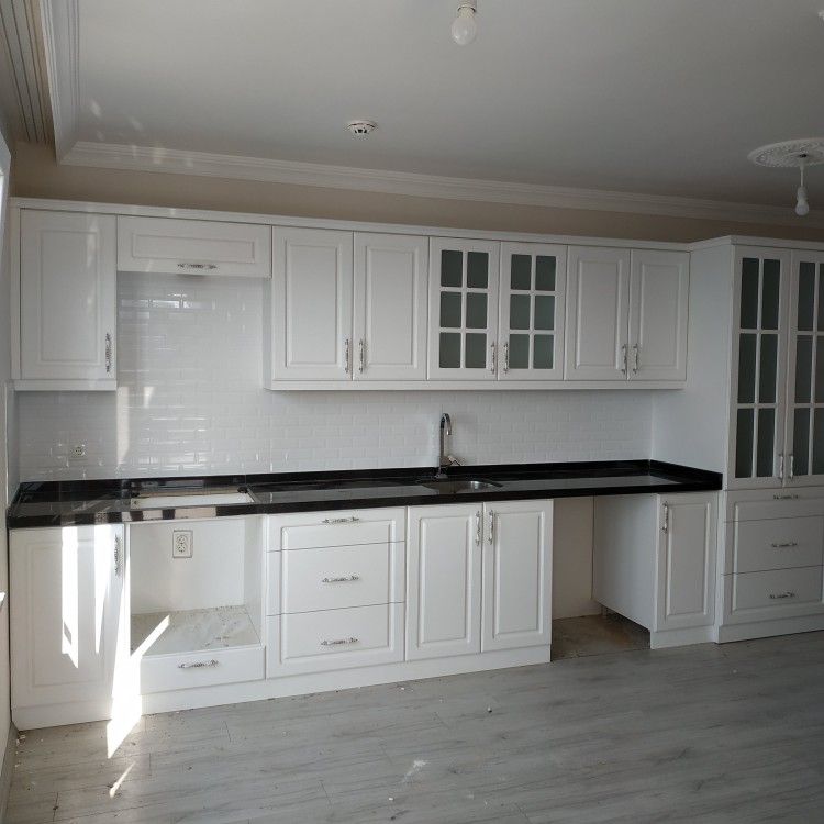 white kitchen cabinets with a black countertop