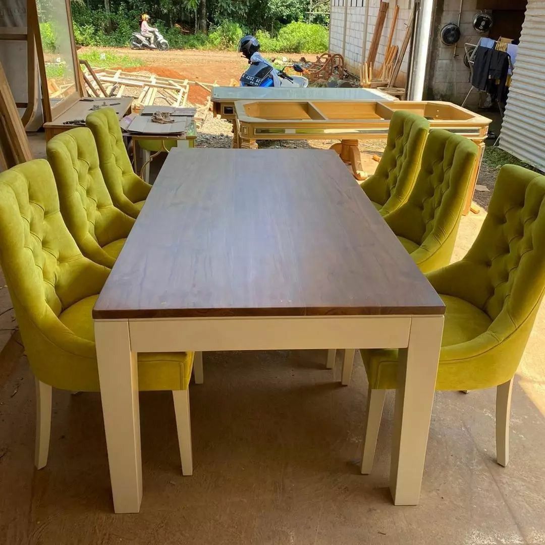 wooden dining table with six upholstered yellow chairs