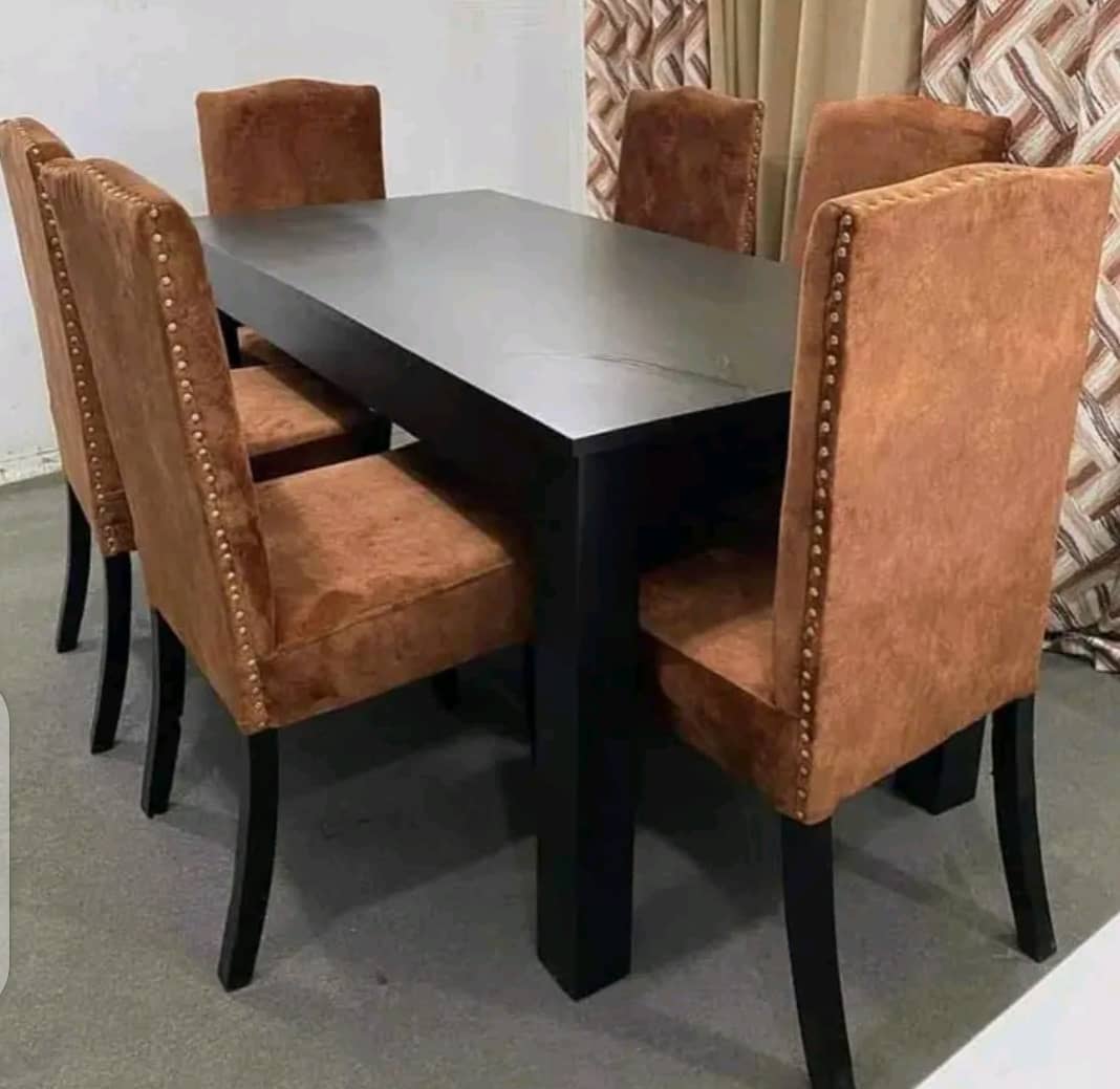 wooden dining table with six upholstered chairs