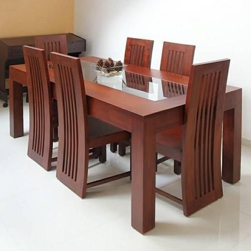 six-seater wooden dining table set with a glass top