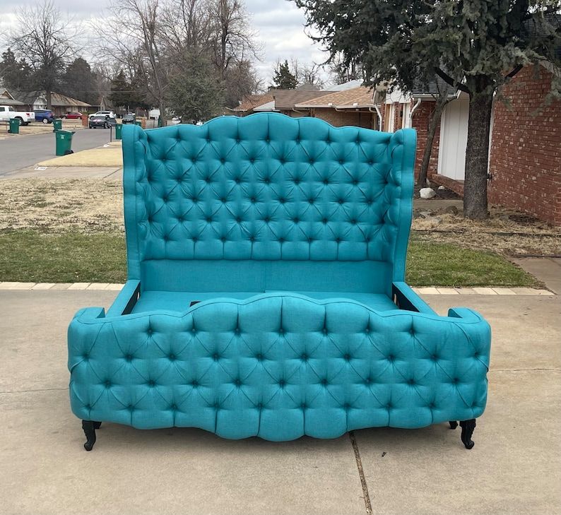 a custom French curved tufted upholstered platform bed frame