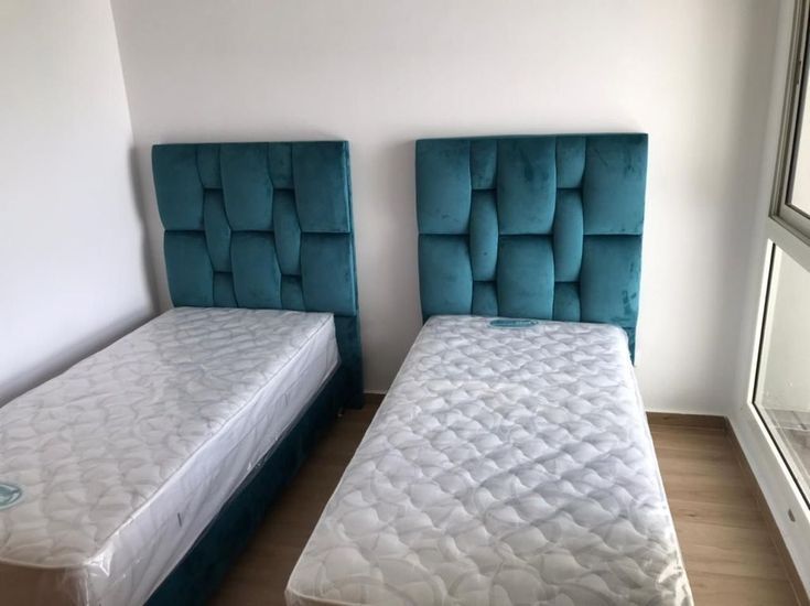 107/02 modern, upholstered bed with a vertically tufted