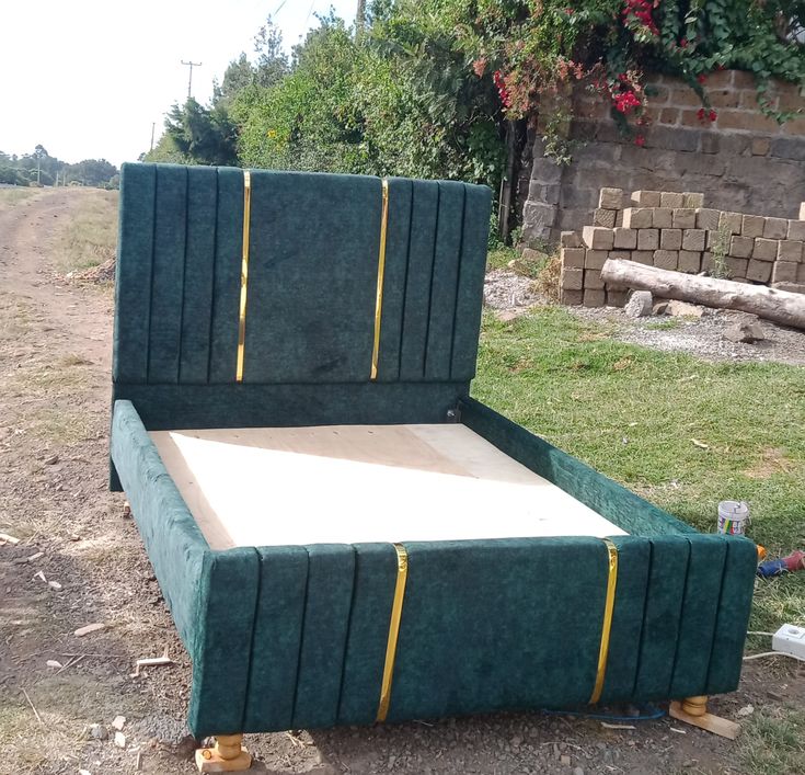 a green velvet upholstered queen-size bed