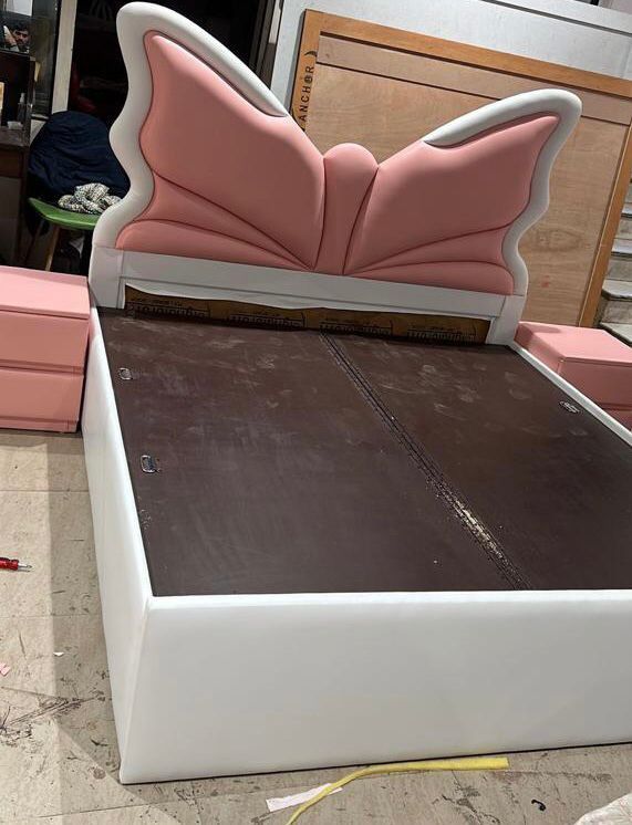 upholstered platform bed with a butterfly-shaped headboard